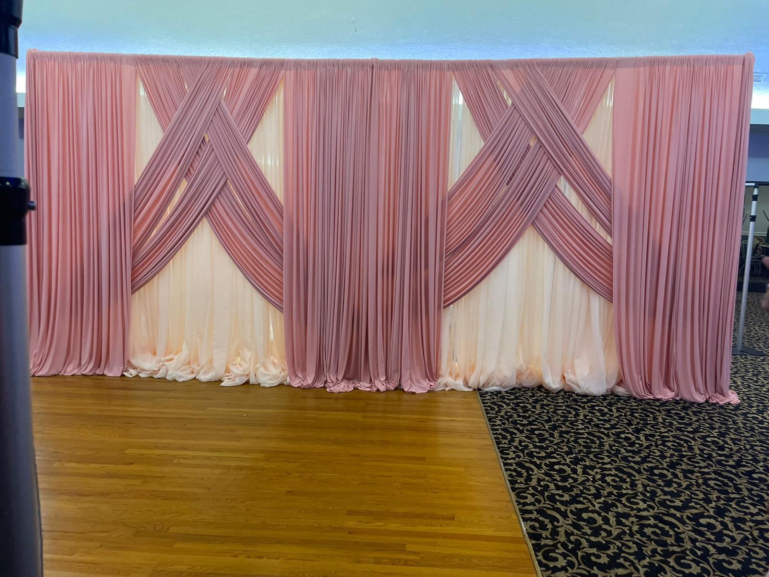 Wide blush and ivory draping installation with symmetrical crossed fabric details